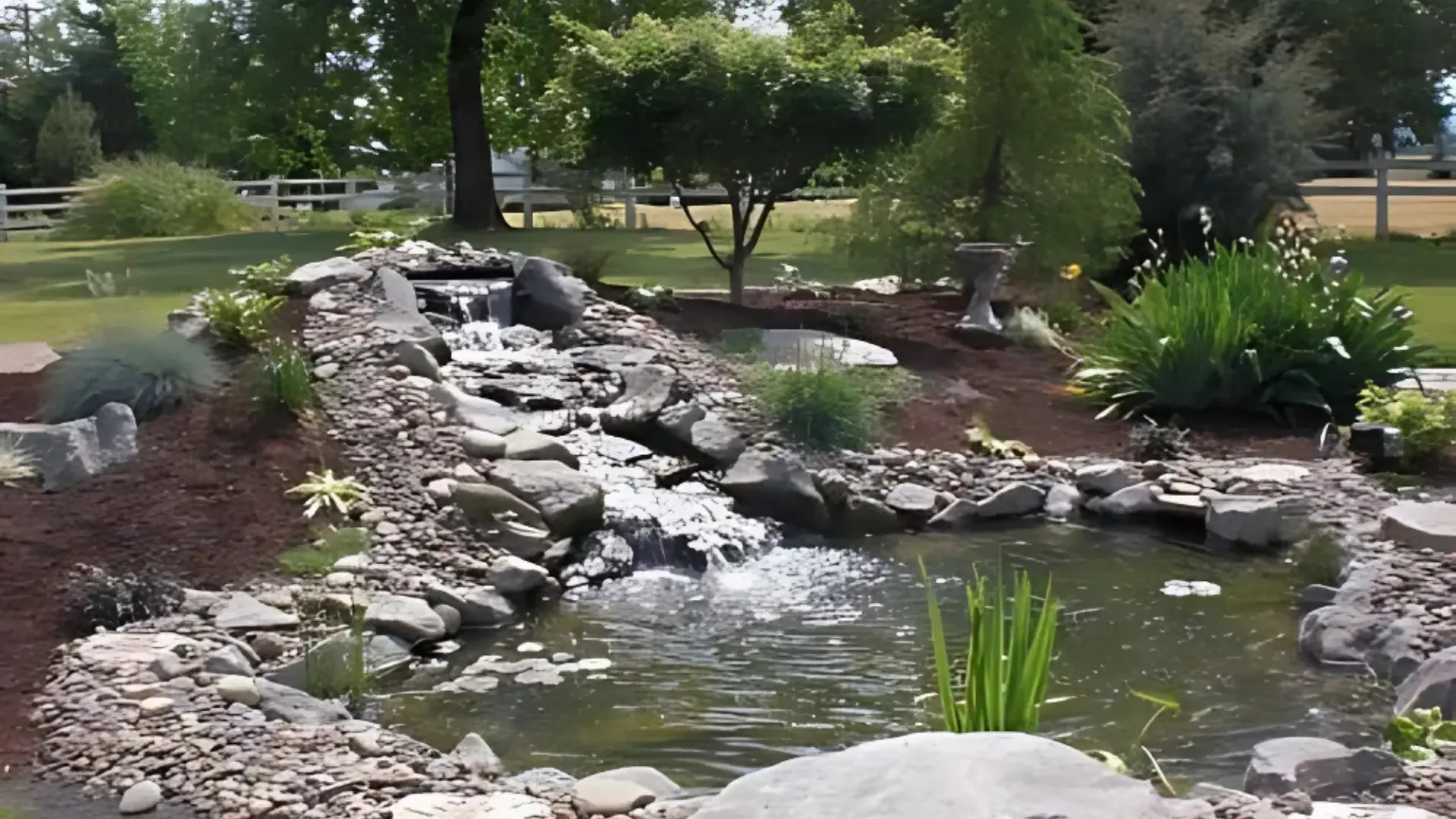 Modern backyard with custom stone patio, fire pit and ambient landscape lighting by AR Landscape